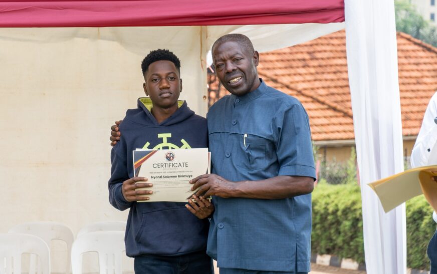 Edward Muhigirwa (R) and student